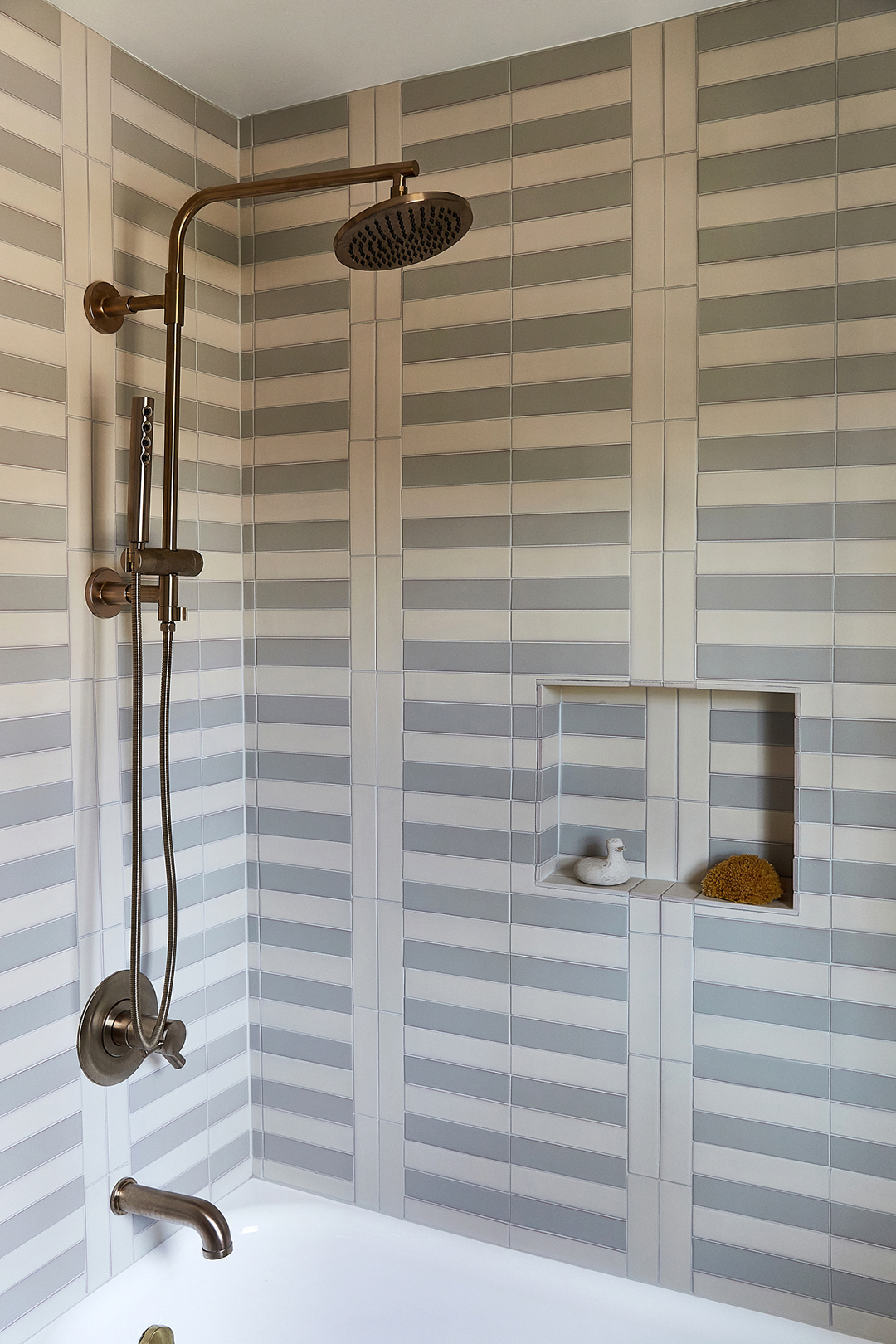 Shower stall with stripe pattern tile on the walls