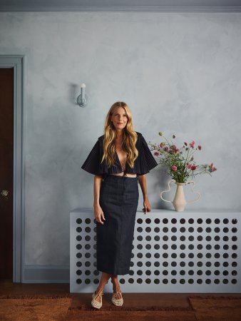 woman leaning on a blue radiator cover