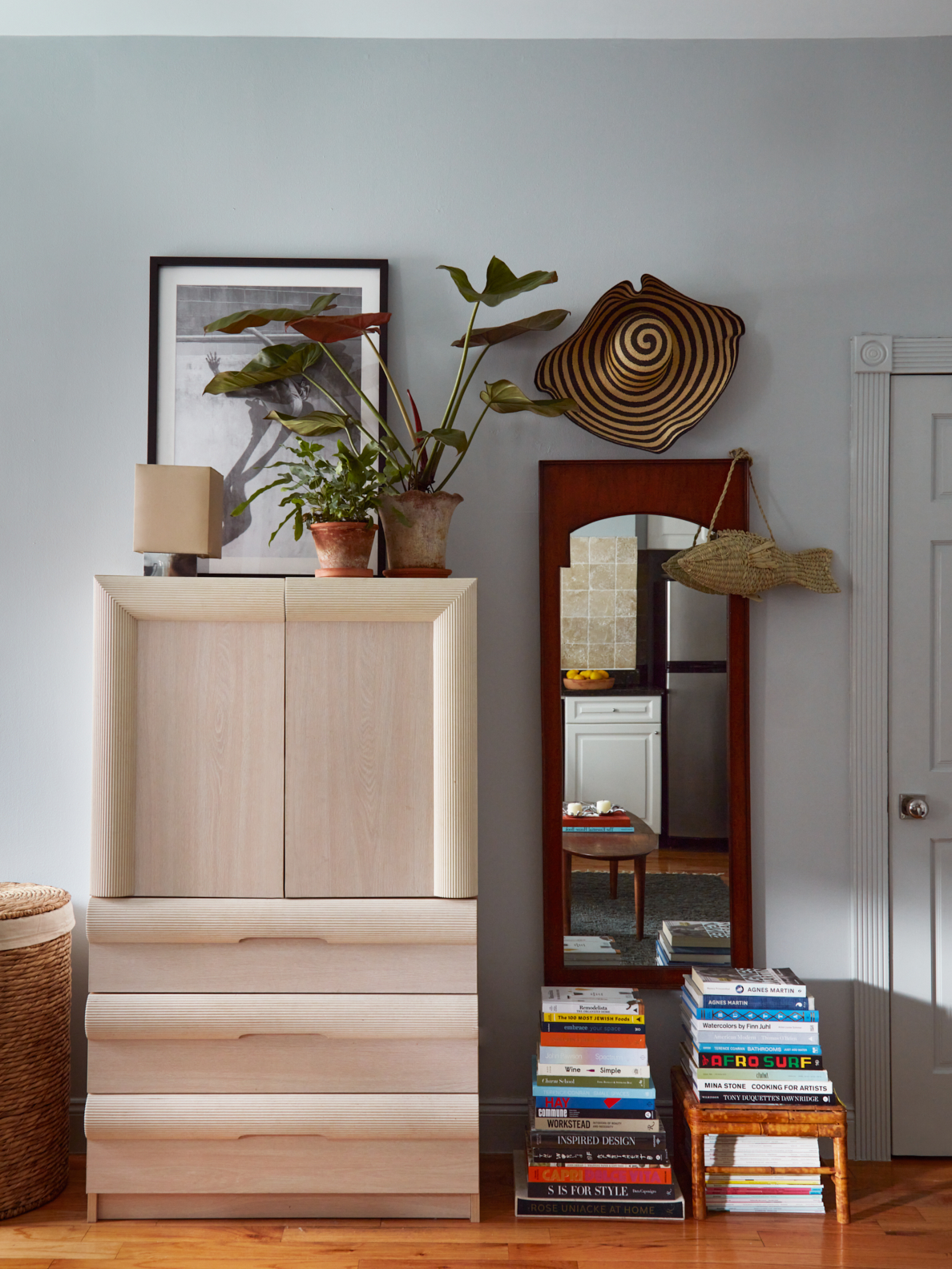 Wardrobe with stack of books beside it