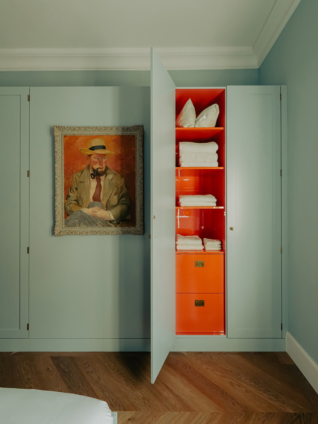 Seaside blue bedroom with built-in cabinet painted orange