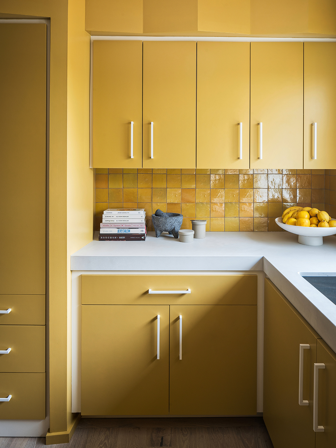 yellow cabinets and backsplash