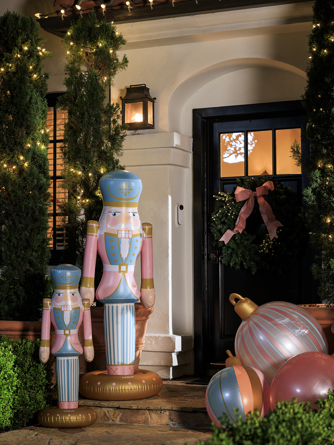 Two inflatable nutcracker decorations at a front door