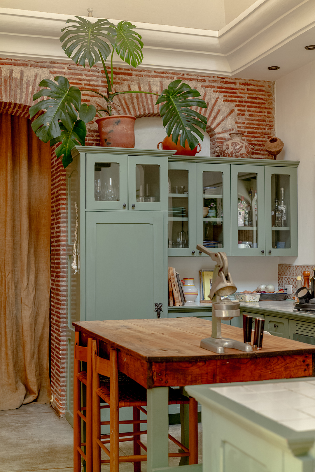 green kitchen with wood island