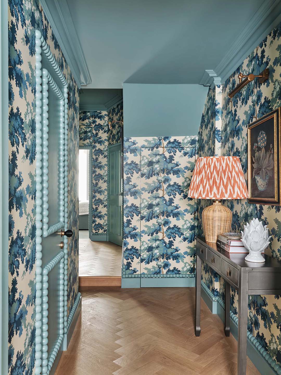 hallway with blue floral wallpaper