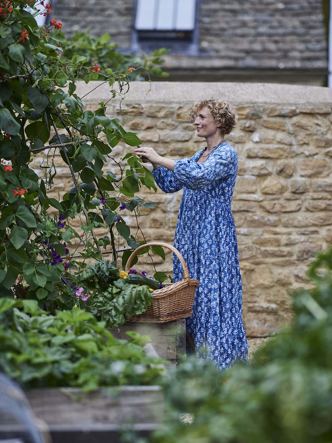 woman pulling veggies in garden