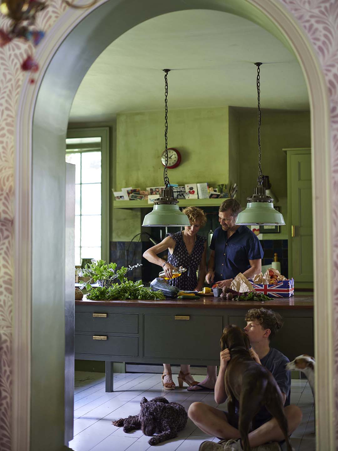 family in green kitchen