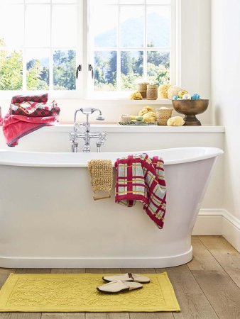 White tub draped with plaid towel