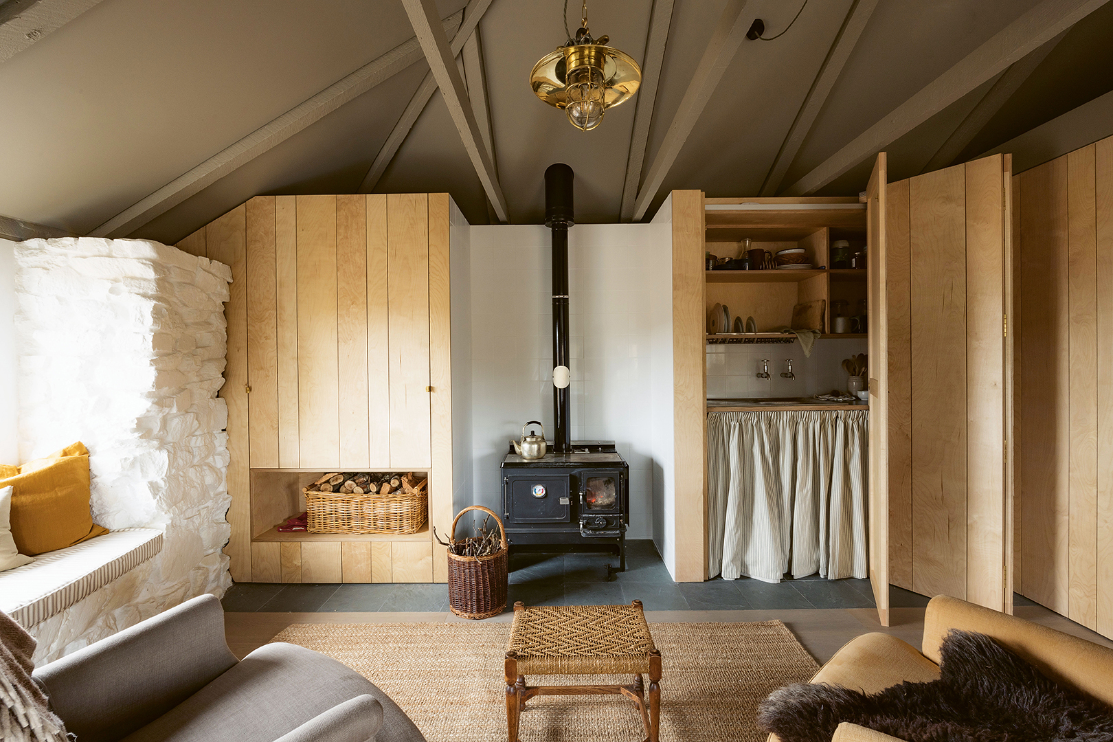 Folding doors reveal a hidden kitchenette.