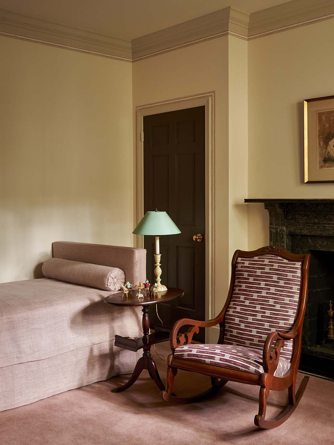 rocking chair next to pink bed