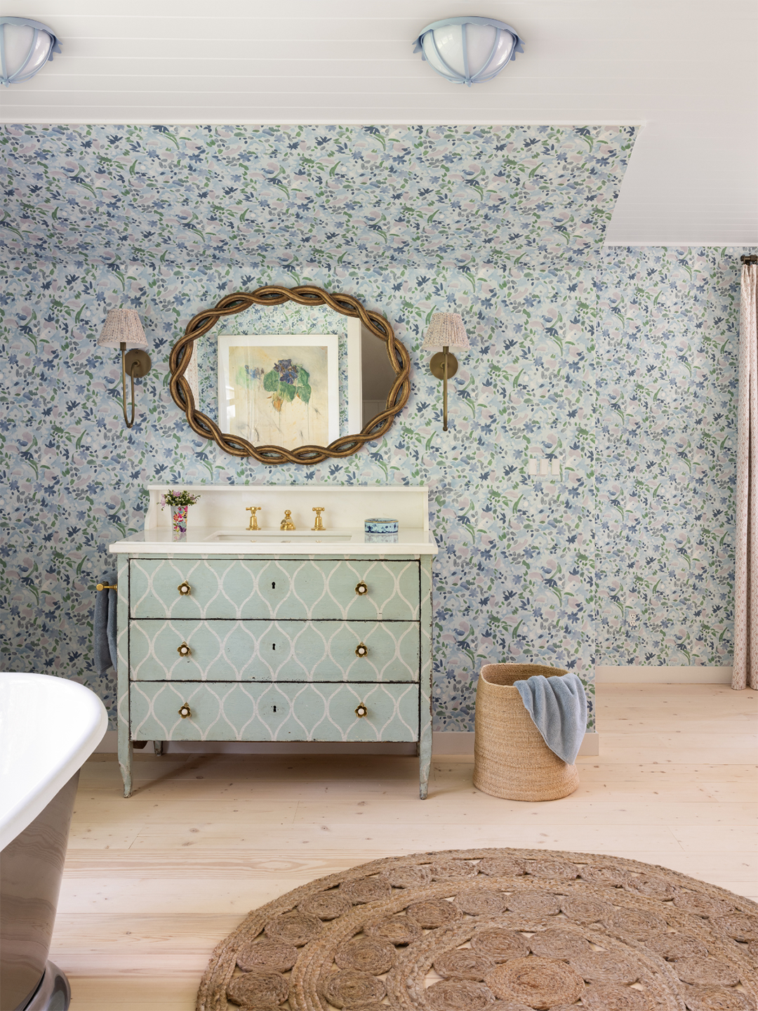 A bathroom with patterned wallpaper.