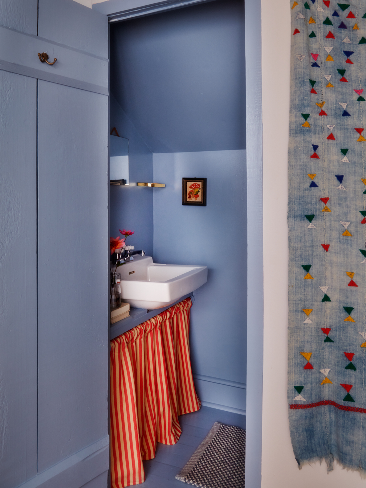 Powder room with skirted sink.