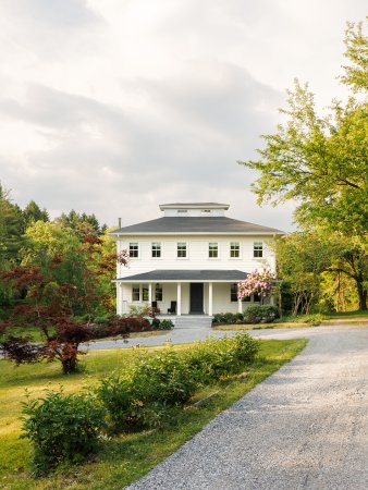 White colonial with long driveway