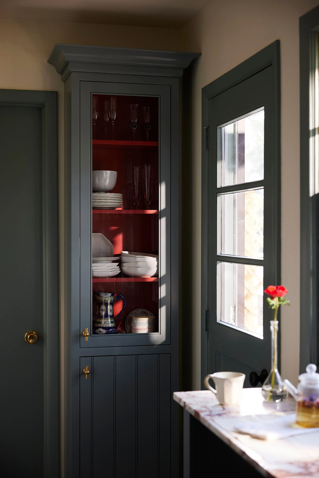 glass front cabinet with red interior