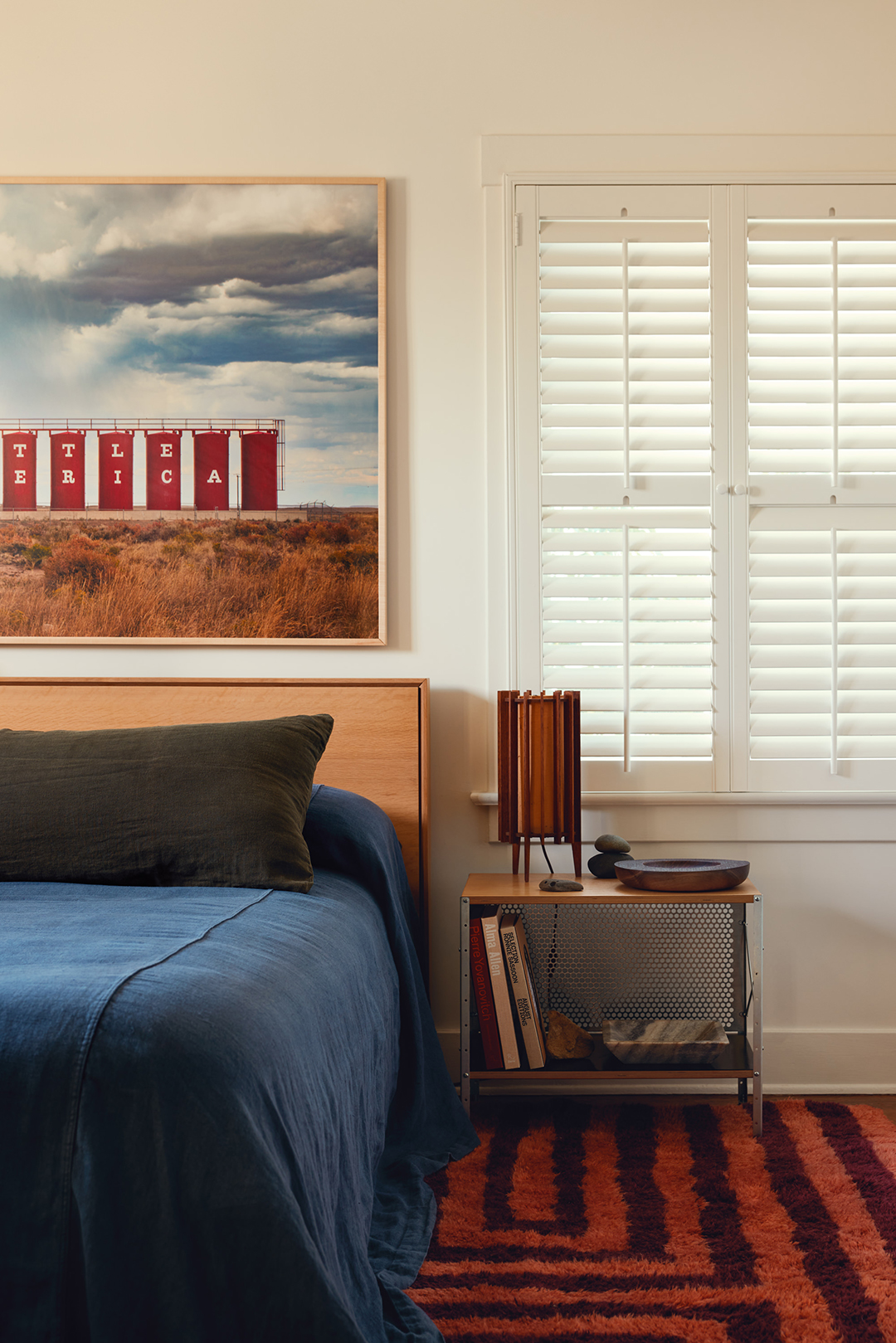 blue bedding with striped rug